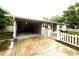 Carport with a view of the house and a white picket fence at 7814 Plunkett Ave, Orlando, FL 32810