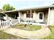 Charming front porch featuring seating, a Ring doorbell, and a well-manicured garden at 7814 Plunkett Ave, Orlando, FL 32810