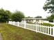 Well-kept front yard with a white picket fence and view of the home at 7814 Plunkett Ave, Orlando, FL 32810