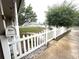 Home's front yard with a white picket fence, mailbox and mature trees at 7814 Plunkett Ave, Orlando, FL 32810