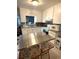 Bright kitchen featuring white cabinetry, granite countertops, and stainless steel appliances at 7814 Plunkett Ave, Orlando, FL 32810