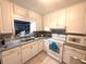 Bright kitchen with white cabinetry, granite countertops, and stainless steel appliances at 7814 Plunkett Ave, Orlando, FL 32810