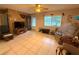 Spacious living room featuring tile flooring, neutral walls, and a ceiling fan at 7814 Plunkett Ave, Orlando, FL 32810