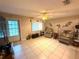 Cozy living room featuring tile flooring, neutral walls, and a ceiling fan at 7814 Plunkett Ave, Orlando, FL 32810
