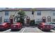 Building with multiple units, each with reserved parking spaces, decorative doors and tropical landscaping at 6294 River Run Pl # 193, Orlando, FL 32807