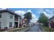 A street view showing apartments and townhomes with red tile roofs and red railings in a residential neighborhood at 6294 River Run Pl # 193, Orlando, FL 32807