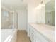 Bathroom featuring separate soaking tub, glass shower and double sink vanity at 2173 Emma Ln, Lake Wales, FL 33859