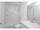 Bright bathroom featuring a shower-tub combo with white tile and a single sink vanity at 2173 Emma Ln, Lake Wales, FL 33859