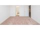 Carpeted bedroom space with open door, neutral walls, and a bright, airy feel at 2173 Emma Ln, Lake Wales, FL 33859