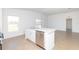 Modern kitchen island featuring a stainless steel dishwasher and a sink with views to the backyard at 2173 Emma Ln, Lake Wales, FL 33859