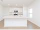 Modern kitchen featuring a breakfast bar, stainless steel appliances, and sleek white cabinetry at 2173 Emma Ln, Lake Wales, FL 33859