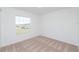 Bright bedroom with neutral walls and carpeted floor at 322 Brennan Ave, Frostproof, FL 33843