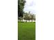 Expansive backyard with a lake view and wooden dock extending into the water with lush trees at 1019 Grove St # 85, Maitland, FL 32751