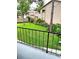 A balcony view of a grassy backyard with beautiful landscaping and tan buildings nearby at 1019 Grove St # 85, Maitland, FL 32751