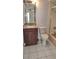 A neutral bathroom with a brown granite vanity, neutral tile floors, and a glass enclosed shower/tub at 1019 Grove St # 85, Maitland, FL 32751
