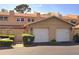Townhouse exterior with two-car garage, neutral stucco, tidy landscaping, and brick-paved driveway at 1019 Grove St # 85, Maitland, FL 32751