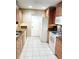 Updated kitchen featuring tile floors, light wood cabinets, granite counters, and white appliances at 1019 Grove St # 85, Maitland, FL 32751
