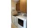 Laundry room featuring washer, dryer, upper cabinets, and beige tile flooring at 1019 Grove St # 85, Maitland, FL 32751