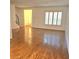 Spacious living room featuring hardwood floors, staircase, large windows, and white walls at 1019 Grove St # 85, Maitland, FL 32751