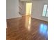 Bright living room with wood floors, stairs, and plantation shutters at 1019 Grove St # 85, Maitland, FL 32751