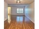 Living room with wood floors, plantation shutters, and modern light fixture at 1019 Grove St # 85, Maitland, FL 32751