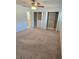 Spacious bedroom with neutral carpet, a ceiling fan, and open closets with storage at 1019 Grove St # 85, Maitland, FL 32751