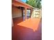 Covered patio with stained concrete, column supports, privacy fence, and gate to the parking area at 1019 Grove St # 85, Maitland, FL 32751