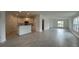 Spacious open-concept layout showcasing tile flooring, kitchen, and abundant natural light at 227 Bryce Ln, Frostproof, FL 33843