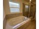 Bathroom featuring a soaking tub and a separate glass-enclosed shower at 216 Harper Estates Cir, Lake Wales, FL 33859