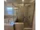 Modern bathroom featuring a soaking tub and a separate glass-enclosed shower at 216 Harper Estates Cir, Lake Wales, FL 33859