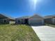 Charming single-story home with a well-maintained lawn and a two-car garage at 216 Harper Estates Cir, Lake Wales, FL 33859