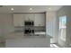 Modern kitchen featuring white cabinets, stainless steel appliances, and an island with a sink at 216 Harper Estates Cir, Lake Wales, FL 33859