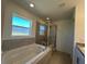 Modern bathroom with a soaking tub, glass-enclosed shower, and tiled walls at 221 Harper Estates Cir, Lake Wales, FL 33859