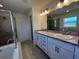 Elegant bathroom with a soaking tub, glass shower, double sink vanity, and sleek lighting at 221 Harper Estates Cir, Lake Wales, FL 33859