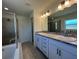 Stylish bathroom with a soaking tub, separate shower, and double vanity with elegant fixtures at 221 Harper Estates Cir, Lake Wales, FL 33859