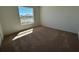 Bedroom features neutral carpet, natural light from window, and fresh paint at 221 Harper Estates Cir, Lake Wales, FL 33859