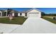 Charming single-story home featuring a two-car garage, well-maintained lawn, and inviting curb appeal at 221 Harper Estates Cir, Lake Wales, FL 33859