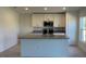 Bright kitchen featuring white cabinets, stainless steel appliances, and a center island with a sink at 221 Harper Estates Cir, Lake Wales, FL 33859