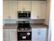 Modern kitchen featuring white cabinetry, stainless steel appliances, and stylish countertops at 221 Harper Estates Cir, Lake Wales, FL 33859