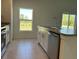 Well-lit kitchen boasts stainless steel appliances, a tile floor, and a view of the outdoors at 221 Harper Estates Cir, Lake Wales, FL 33859