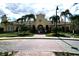 A view of the grand community clubhouse with well-manicured landscaping and inviting entryway at 5002 Tideview Cir # 3, Orlando, FL 32819