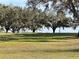 Scenic view of a lush golf course with mature oak trees at 1159 Greenley Ave, Groveland, FL 34736