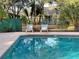 Community pool with lounge chairs and a playground in the background at 1159 Greenley Ave, Groveland, FL 34736