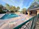 Relaxing community pool area with a covered patio and plenty of seating at 1159 Greenley Ave, Groveland, FL 34736