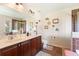 Bathroom with double sinks, a shower, and decorative wall art at 1541 Truscott Ct, Mount Dora, FL 32757