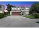 Two-story house with a gray exterior, red door, and landscaped yard at 1541 Truscott Ct, Mount Dora, FL 32757