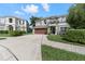 Two-story house with a gray exterior, red door, and landscaped yard at 1541 Truscott Ct, Mount Dora, FL 32757