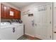 Well-equipped laundry room with washer, dryer, and ample storage at 1541 Truscott Ct, Mount Dora, FL 32757