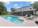 Relaxing pool area with patio furniture and screened enclosure at 1541 Truscott Ct, Mount Dora, FL 32757