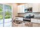 Kitchen with granite countertops, stainless steel appliances, and a large window at 16039 Juniper Inlet Aly, Winter Garden, FL 34787